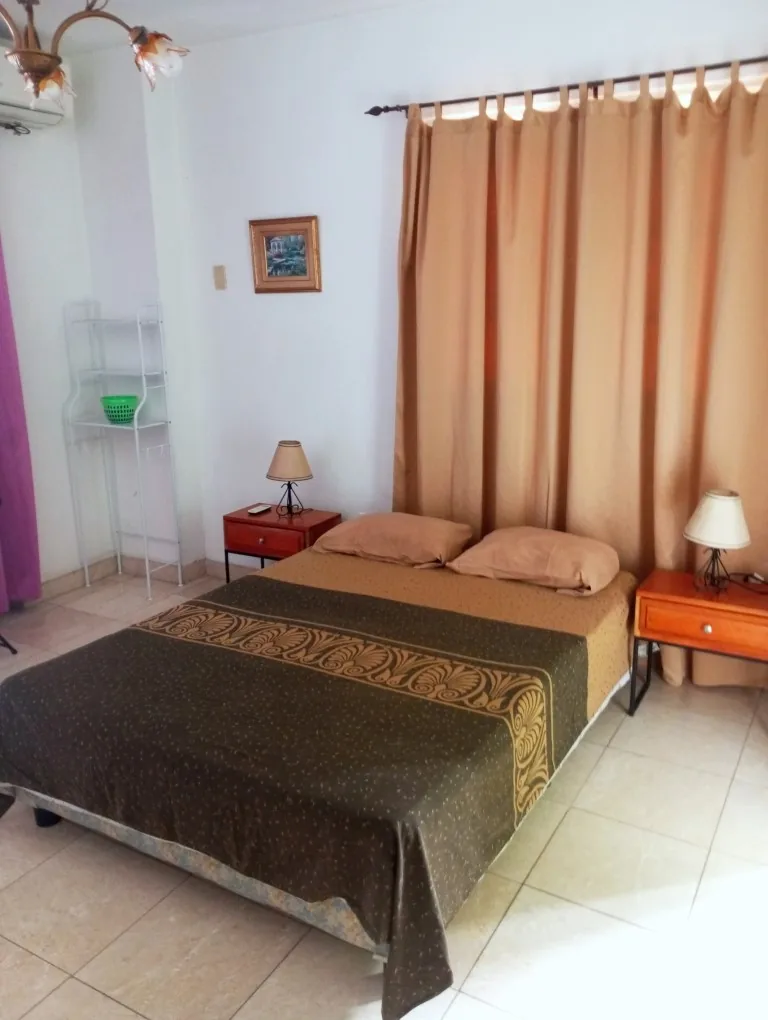 Bedroom of an apartment in Havana with air conditioning and a double bed